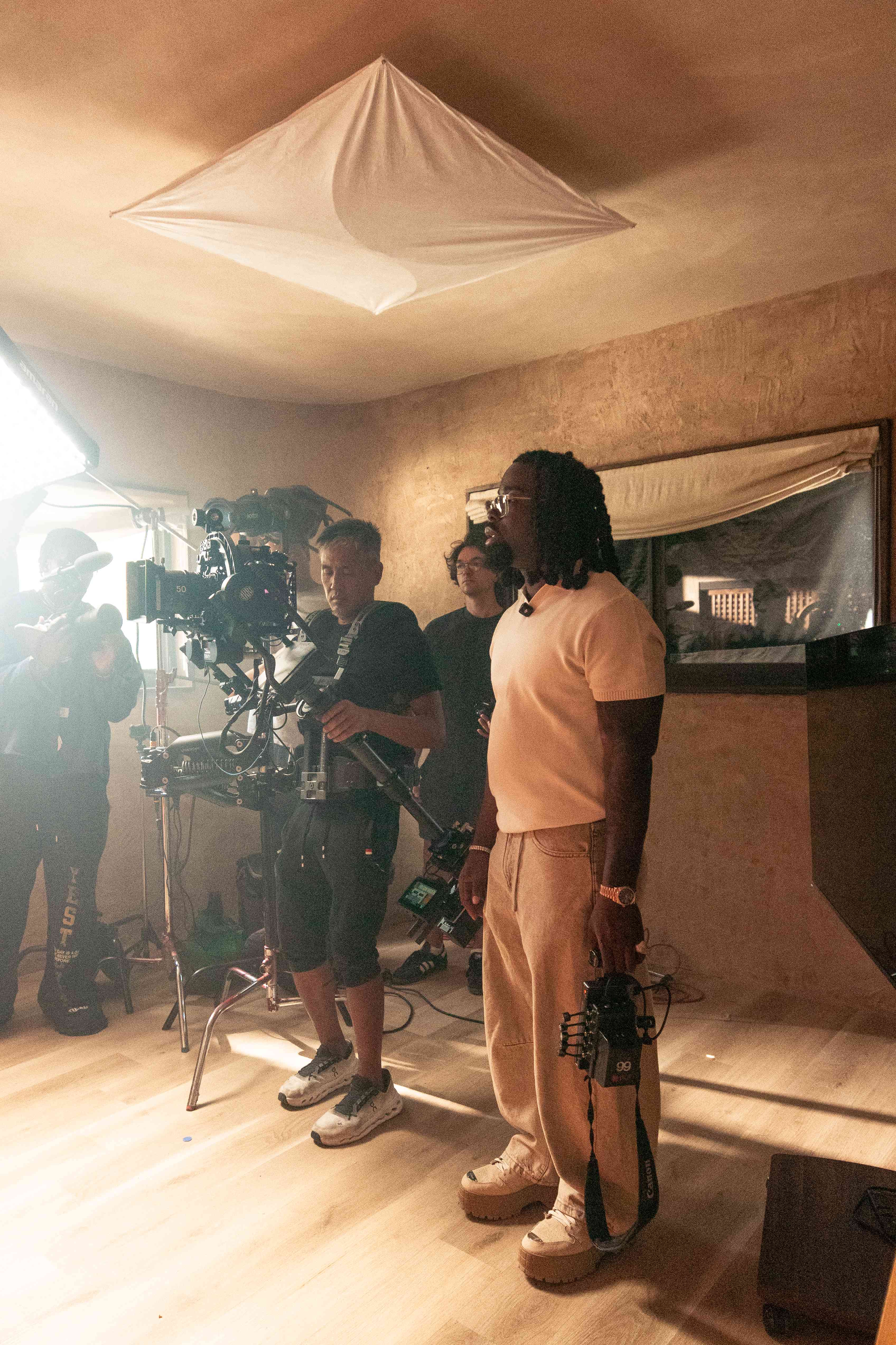 Royal Eyez crew filming on a warmly lit set